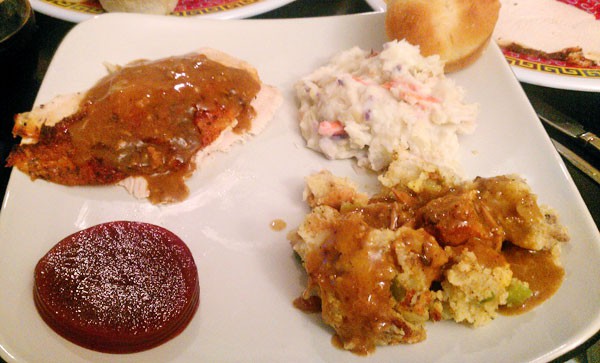 picture of a Thanksgiving day meal on a white plate including turkey with gravy, colcannon, cranberry sauce, and the the sausage cornbread dressing recipe