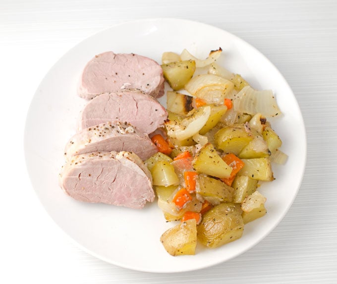 Pork Tenderloin with Roasted Vegetables Recipe | I love this pork tenderloin recipe for easy weeknight dinners! It has little prep and cooks your meat and veggies all in the same pan in under an hour.
