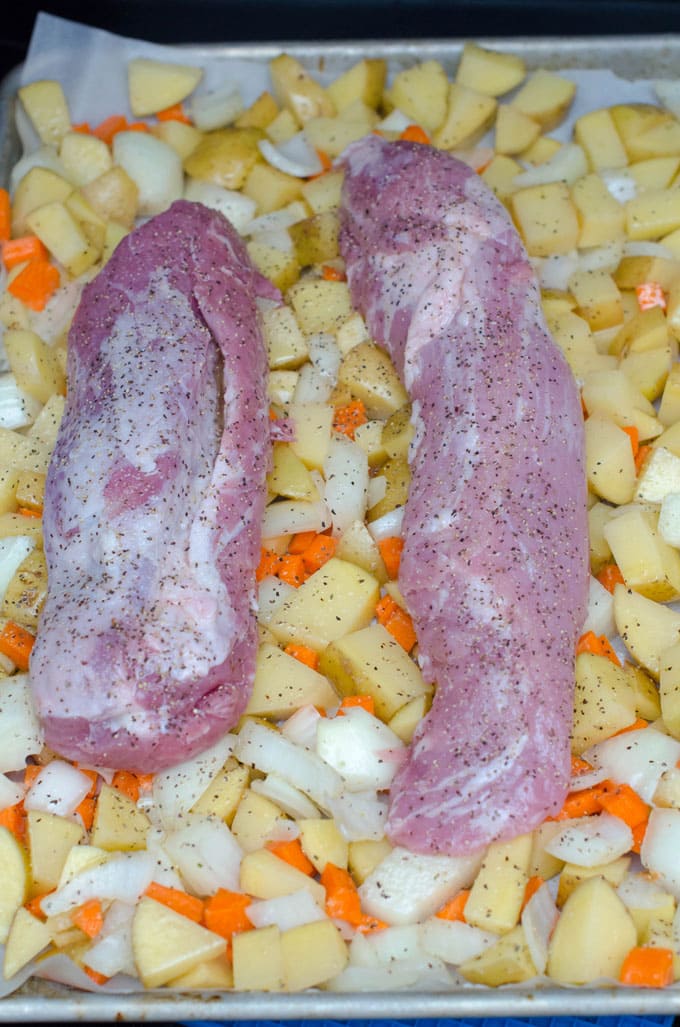 Pork Tenderloin with Roasted Vegetables Recipe | I love this pork tenderloin recipe for easy weeknight dinners! It has little prep and cooks your meat and veggies all in the same pan in under an hour.