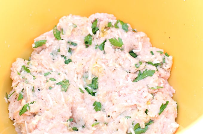 raw chicken parmesan meatball mix in a yellow bowl
